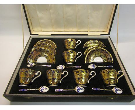 An Aynsley bone china coffee service of six cups and saucers, the cups profusely gilt decorated with flowers on blue backgrou