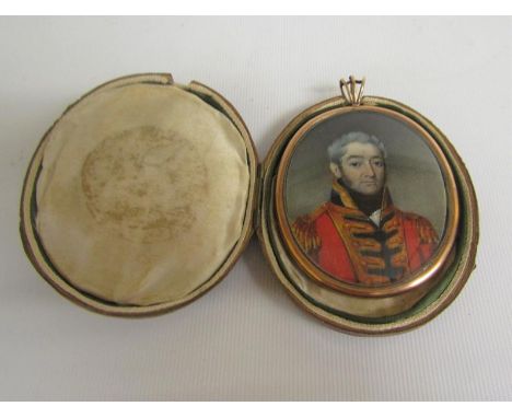 A gilt metal framed oval portrait pendant miniature of an officer in military costume and to the reverse a memoriam panel wit