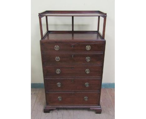 A late Georgian mahogany secretaire chest with upper tier shelf, the secretaire with fall front fitted pigeon holes and five 