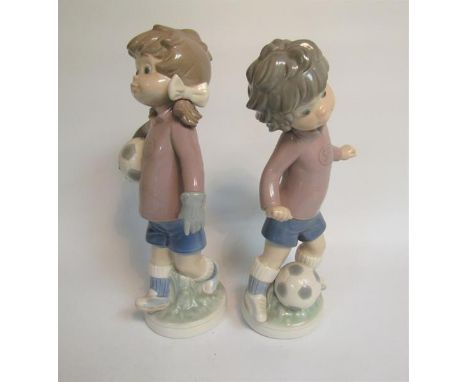 A pair of Lladro porcelain figures, c.1978, Sports Lily Football player, model no.5134 and Sports Billy Football Player, mode