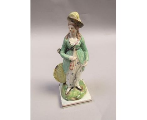 An early 19c square based figure of a lady archer with bow, arrow and target, 