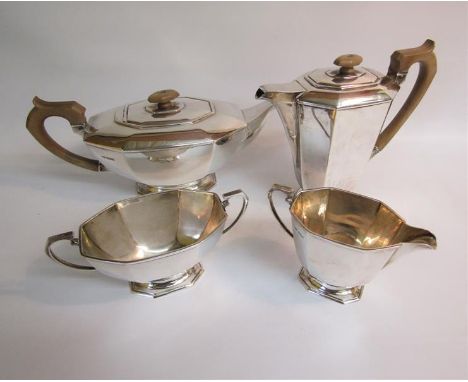 An Art Deco style four piece tea service of faceted form comprising a teapot, water jug, sucrier and cream jug, makers mark F