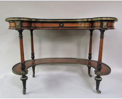 A rare 19c ladies kidney shaped writing table by Gillow of Lancaster.  The top veneered with panels of amboyna inlaid with eb