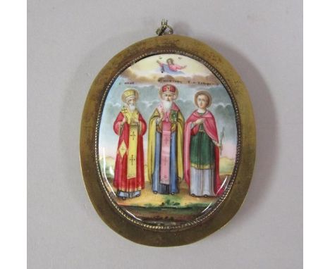 A 19c Continental ceramic icon of slightly domed oval form, depicting three religious figures and within a brass frame, 10cm 