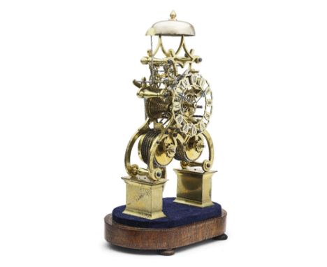 A good 19th century brass skeleton clock with deadbeat escapementUnsignedThe scroll frame united by six turned vase-shaped pi