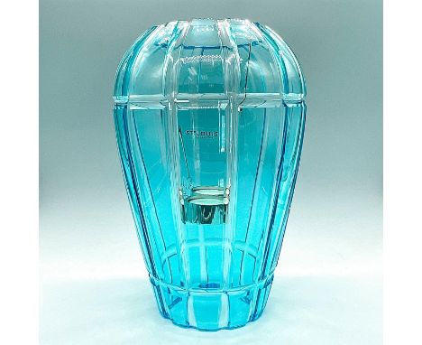 The Saint-Louis En Cage Photophores feature suspended votives within a crystal lantern. When lit, the light refracts against 
