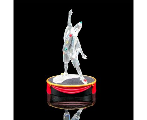 Clear body adorned with red, yellow and green crystal throughout costume. Frosted ruffled collar. Blue inset eyes with black 