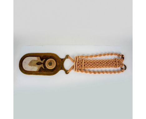 Large and heavy, handcrafted with brass, ceramic, and macrame elements that hang from knotted and braided rope. Signed FW and