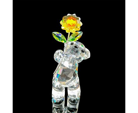 Part of the Kris Bear series. Lead crystal figure of the kris bear holding a flower with silver tone stem. Swarovski etched b