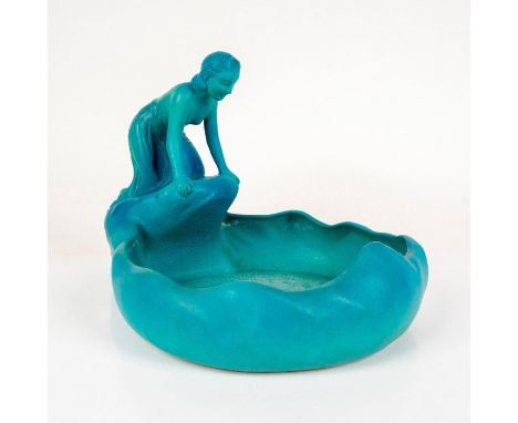 A blue glaze ceramic figural bowl of a woman leaning over a lake. Van Briggle Pottery carved backstamp on the base. Issued: c