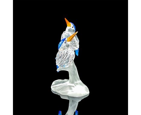 Two clear crystals birds perched on a frosted branch. Sapphire crystal tails, hoods, and wings, and topaz crystal beaks. Swar
