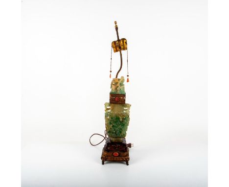 A beautiful lamp of a covered jade vase adorn with blossom carving, a bird perched on the lid, and carnelian agate medallions
