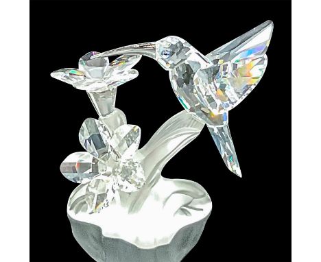 Clear crystal hummingbird and flowers on a frosted base. Blue and black crystal eyes. Swarovski acid mark. This item has its 