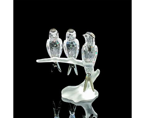 Three clear faceted crystal birds with black diamond stain crystal head and tail feathers. Perched on a frosted branch. Swaro