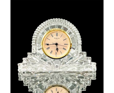 A heavy Waterford crystal mantle clock in the Wharton pattern which features a fan style base and a round gold clock face. Wa