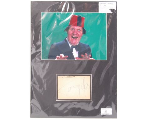 An original vintage autograph album page signed by Comedian / Magician Tommy Cooper . Signed neatly in blue ink, the album pa