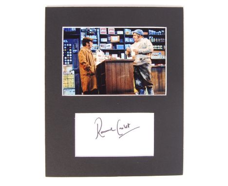 An original autograph of Ronnie Corbett, mounted beneath an image of The Two Ronnies performing the infamous Fork Handles ske