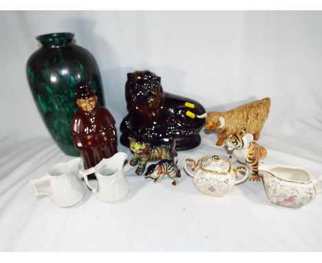 A good mixed lot of ceramics to include Sadler milk jug and sugar bowl, a large ceramic lion, a decanter in the form of a Vic