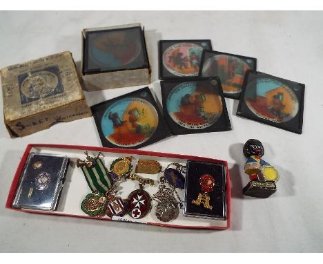 A mixed lot of enamel badges and similar, some of which are hallmarked silver and a boxed set of coloured lantern slides, Jun
