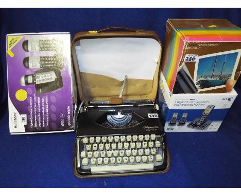 A mixed lot to include an Olympia Splendid 99 typewriter in a carry case, a collection of phones and a Polaroid colour swinge