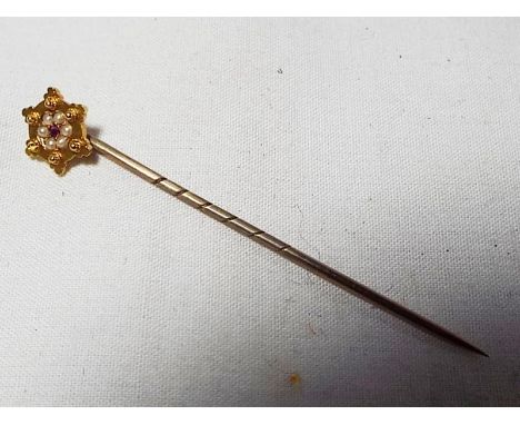 A yellow metal stick pin marked 15ct set with rubies and pearls in original case