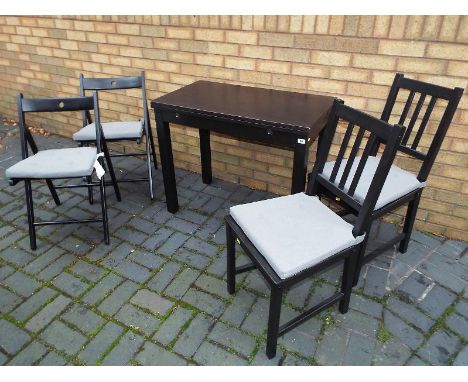 A compact modern dining set comprising flip-top table, two dining chairs and two folding chairs, black 75cm (h) x 80cm (w) fo