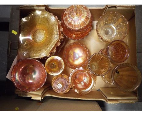 A collection of approximately 15 pieces of carnival glass to include bowls, plates, lidded trinket dishes, twin handled bowl 