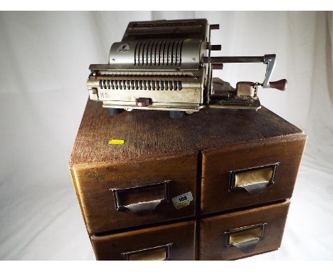 An oak 4 drawer vintage filing box by James Getns of London and a vintage adding machine marked Grunsvigna Olympia Business C