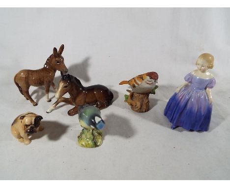 Six ceramic figurines comprising Royal Doulton Marie HN1370, Beswick donkey, Beswick foal lying #915, Beswick blue tit, Royal