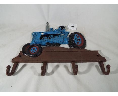 A cast iron coat rack in the form of a tractor