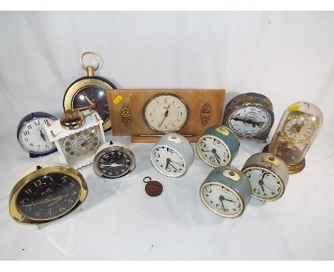 A collection of clocks to include a Tempora mantel clock, Smith English System clock and a collection of alarm clocks to incl