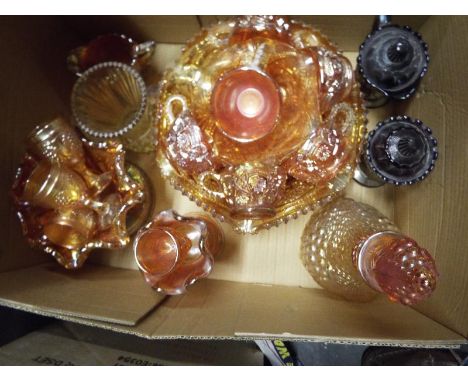 A collection of approximately 20 pieces of carnival glass to include a punch bowl and cups, wine glasses , a decanter and sim