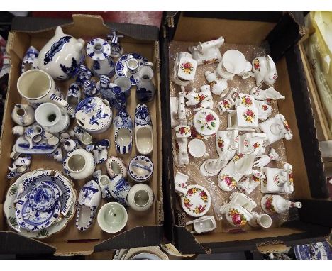 Two boxes containing ceramic collectables to include Delph ware and a collection of Coutry Rose Fine Bone china ornaments. (2