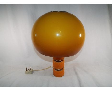 A mid century orange table lamp