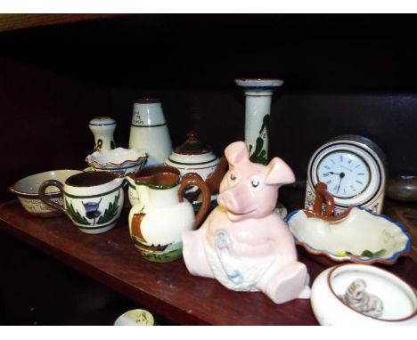 A shelf lot consisting of a collection of Torquay Ware to include vases milk jug trinket boxes, a Wade pig, two vintage woode