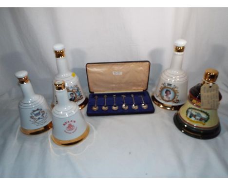 A collection of five Wade Scotch Whisky porcelain decanters and a set of artistic treasures spoons depicting Royal symbols