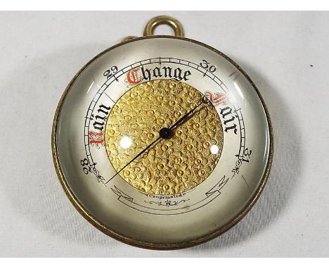 A late 19th / early 20th century miniature barometer with bullseye lens, silvered chapter ring with central floral pattern, 6