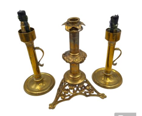 Brass candlestick with a knopt stems and triform base, together with two other brass candlestick 
