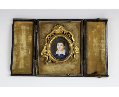 A Victorian watercolour on ivory bust length portrait miniature of a young boy, late 19th century, the boy dressed in lace co