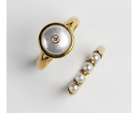 A pearl and diamond ring, comprising a round mabe pearl measuring 9mm diameter, with a small round brilliant cut diamond moun