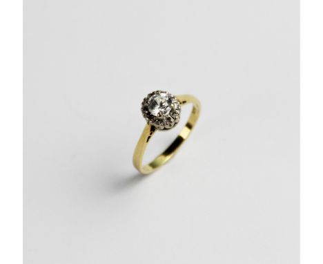 A zircon and diamond 18ct gold cluster ring, comprising a central round brilliant cut white zircon measuring 5mm diameter, wi