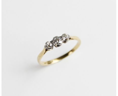 A diamond three stone ring, the central oval old cut diamond measuring 4mm x 3mm x 2.5mm, with a round old cut diamond to eac