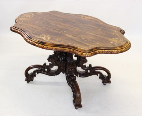 A Victorian rosewood centre table, the shaped top inlaid with foliate sprigs united by stringing, and framed by a moulded bal