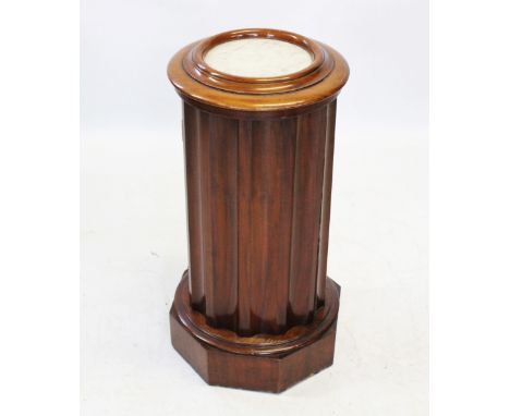 A Victorian mahogany marble top pedestal cupboard, the circular moulded top inset with a white marble slab, upon a fluted ped