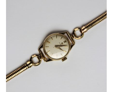 A lady's vintage Omega 9ct gold wristwatch, the round cream dial with baton markers set to a plain polished 9ct gold case, 18