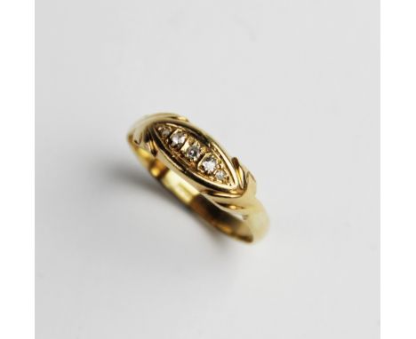 An Edwardian diamond and 18ct gold ring, comprising five graduated mine cut diamonds set to a marquise shaped central panel, 