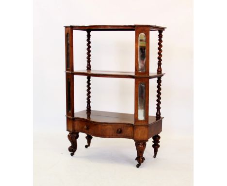 A William IV rosewood etagere/what-not, of serpentine form with three shelves, separated by mirrored and canted front support