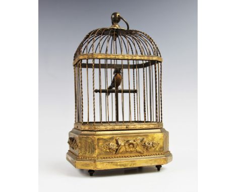 A late 19th century/early 20th century French singing bird automaton, the single bird upon a t-bar post enclosed within a lac