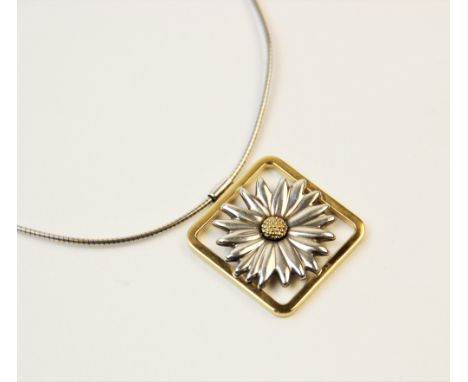 A Tiffany 18ct gold and silver daisy pendant, designed as a two-colour moulded daisy set to a square border surround, 26mm x 