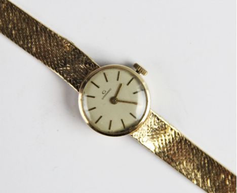 A lady's vintage 9ct gold Garrard wristwatch, the round cream dial with baton markers, set to a plain polished case, 20mm dia